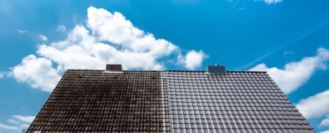 A half cleaned house roof shows the before and after effect of a roof cleaning.
