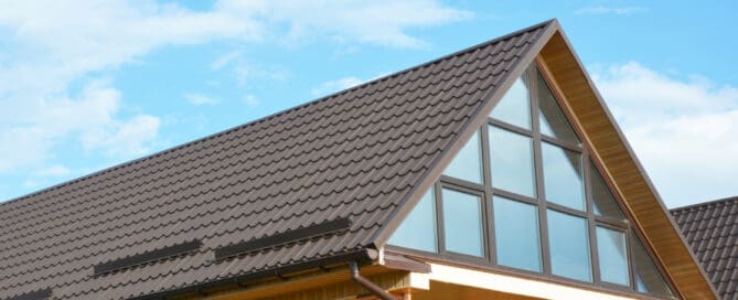 Side view of brown shingle roof in house with windows