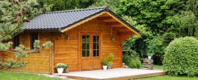Small shed made of wood in yard.