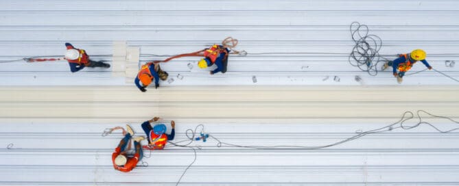 Top view of commercial roofs with workers.