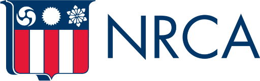 The NRCA logo featuring a shield with red and white vertical stripes on the bottom half and blue background on the top half containing three symbols: a swirl, a circle, and a snowflake. The letters "NRCA" are written in blue to the right of the shield.