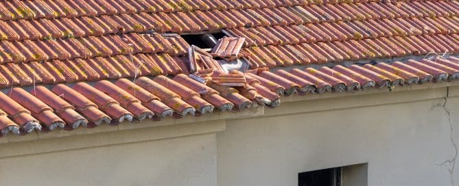 A roof with tiles missing or damaged, showing the gaps and areas that may need repair.