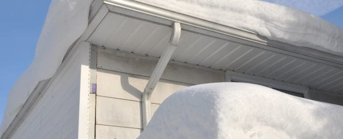 Thick snow on roof of house.