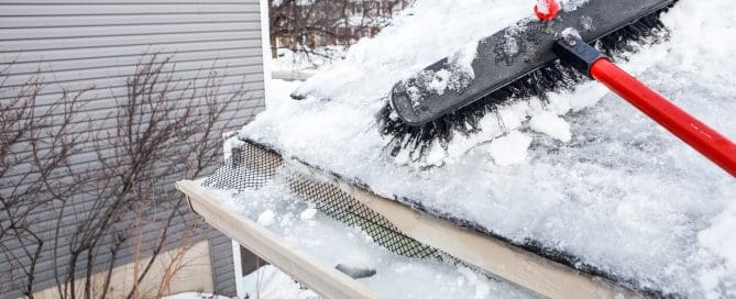 Gutters with ice dam and broom for raking snow off of roof