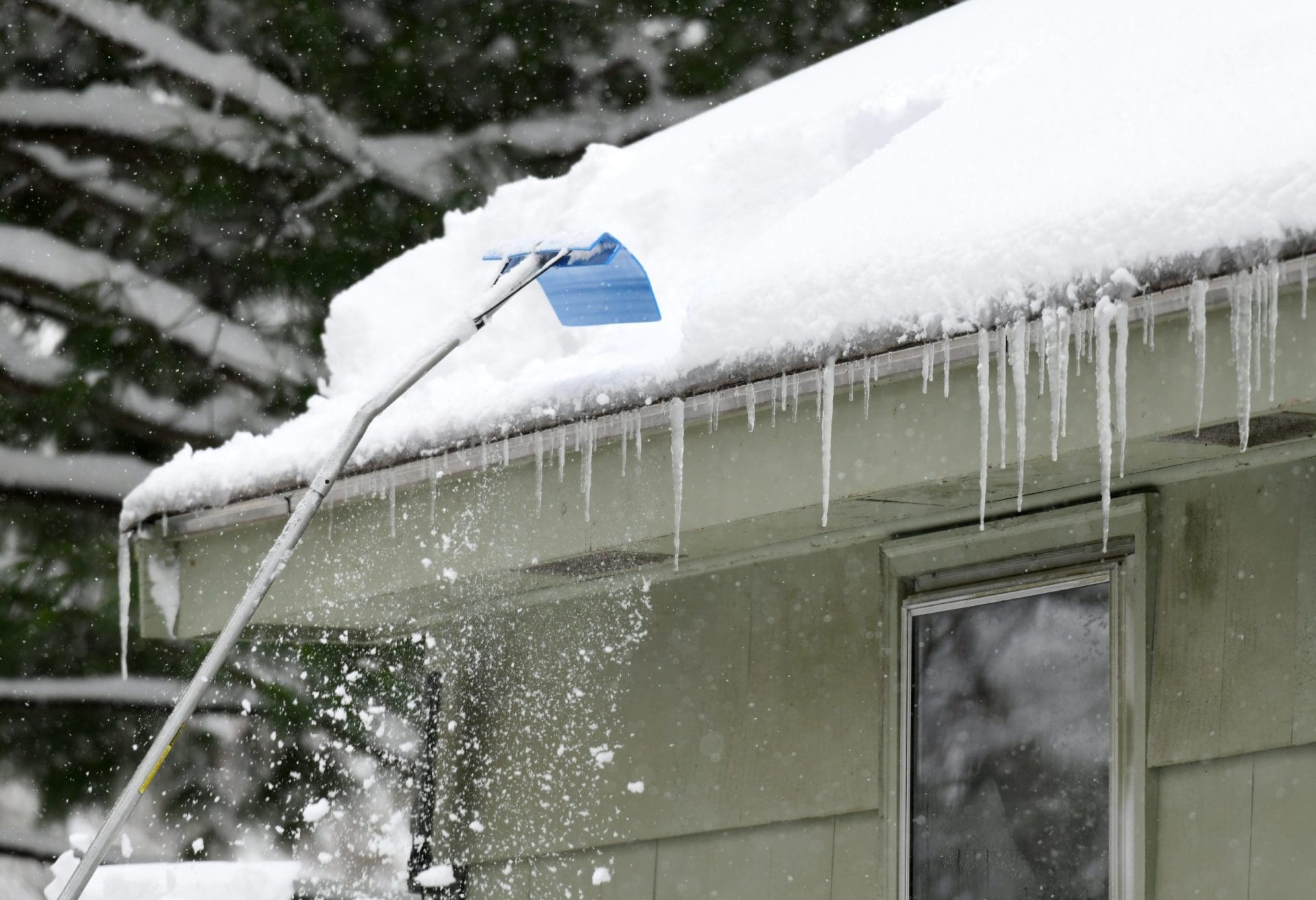 Removing snow on the roof after snow storm