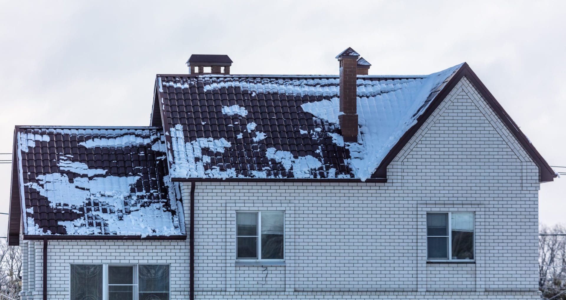 Snow on the roof of the house.