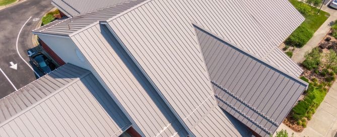Sunny Mid Day Drone Image of Standing Seam Metal Roof on a Commercial Building.