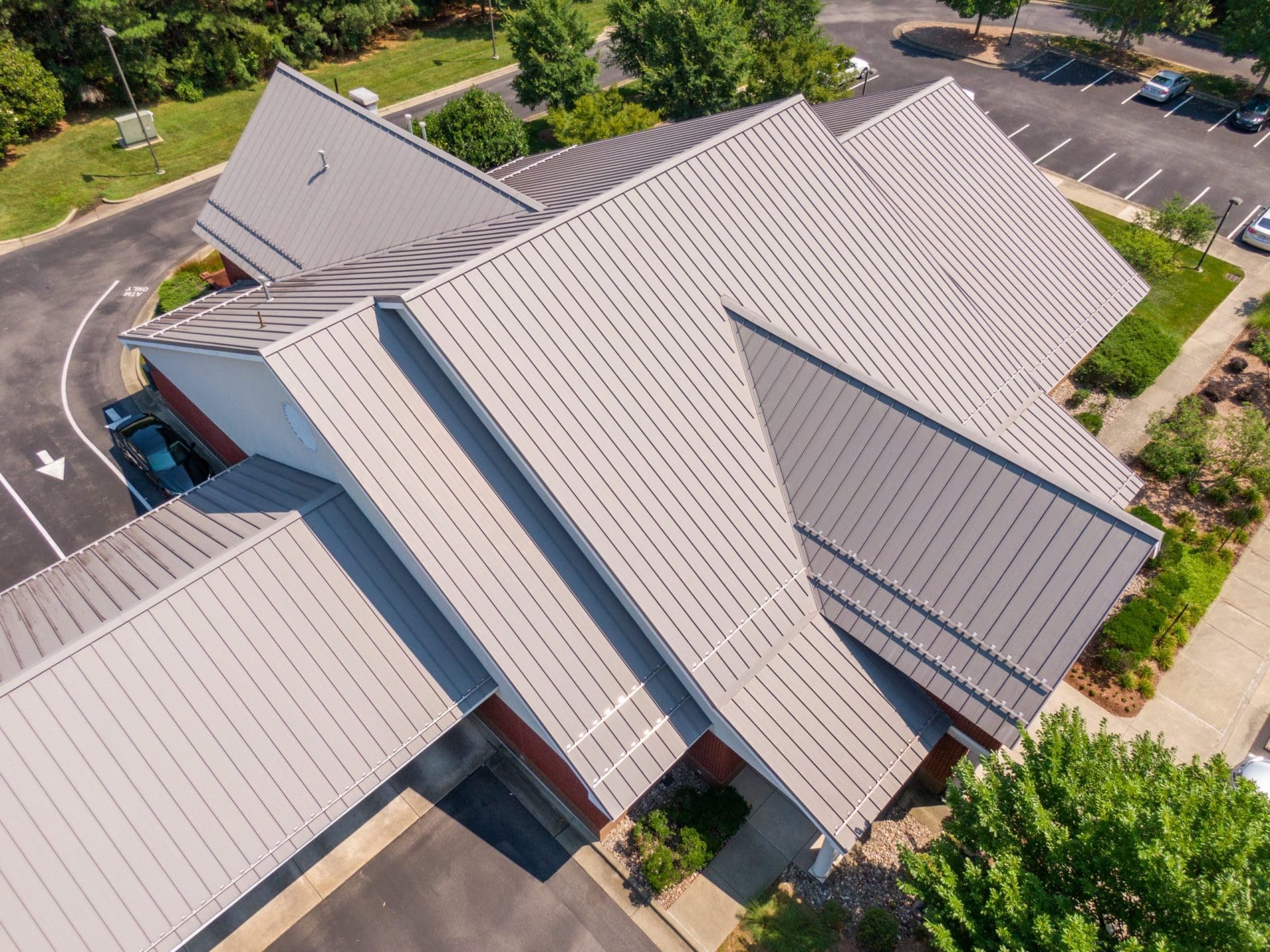 Sunny Mid Day Drone Image of Standing Seam Metal Roof on a Commercial Building.