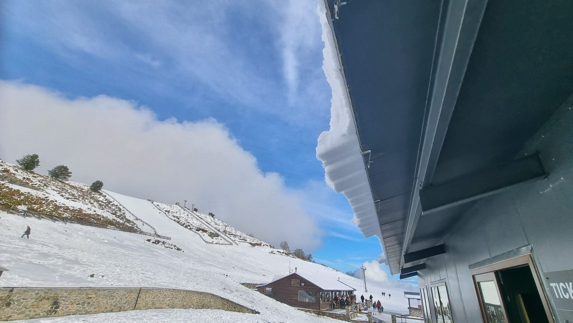 Snow falling from roof.