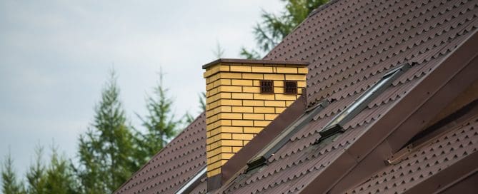 Brick chimney on the roof of the house.