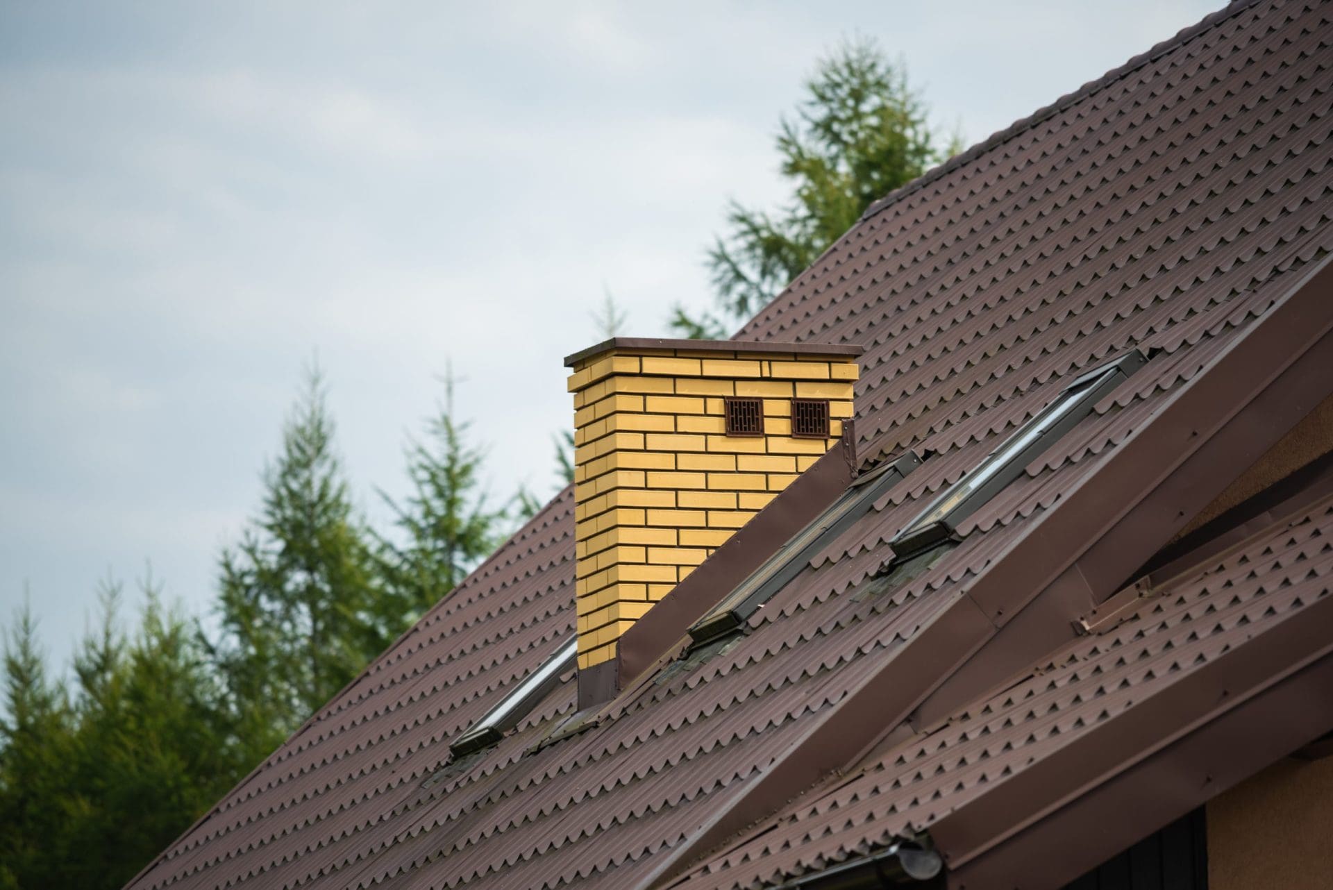 Brick chimney on the roof of the house.