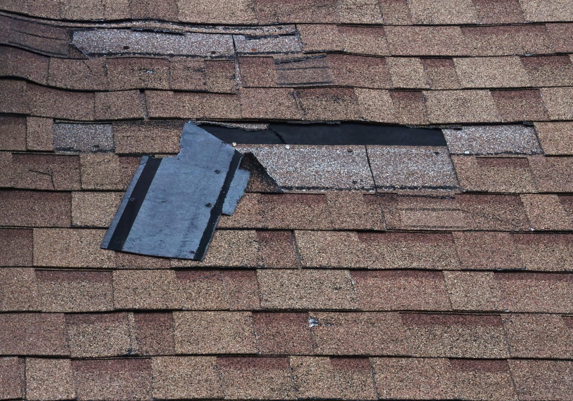 Close-up of broken shingles on roof.